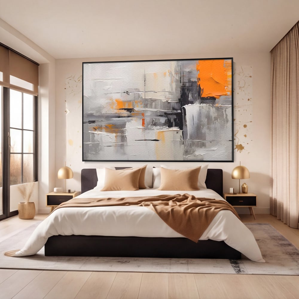 Tablou canvas cu pictura abstracta gri cu pata portocalie, in rama de aluminiu negru, pe perete intr-un dormitor